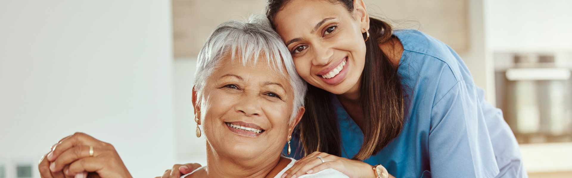 senior woman sitting on the sofa and her caregiver