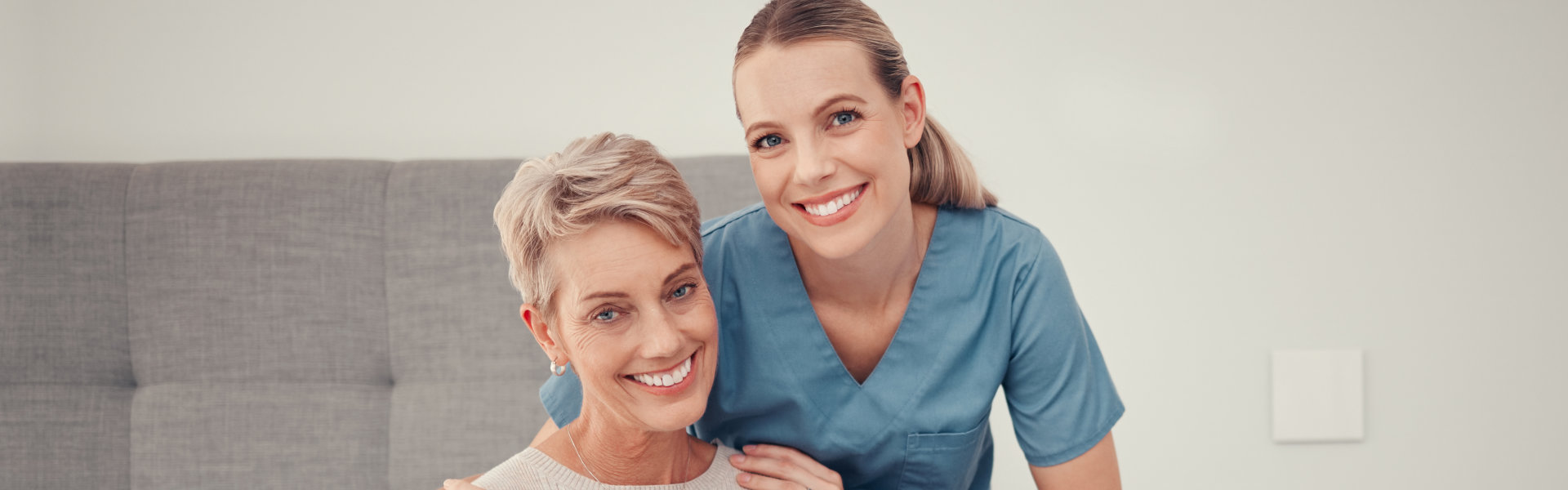 caregiver and senior woman sitting in the bedroom