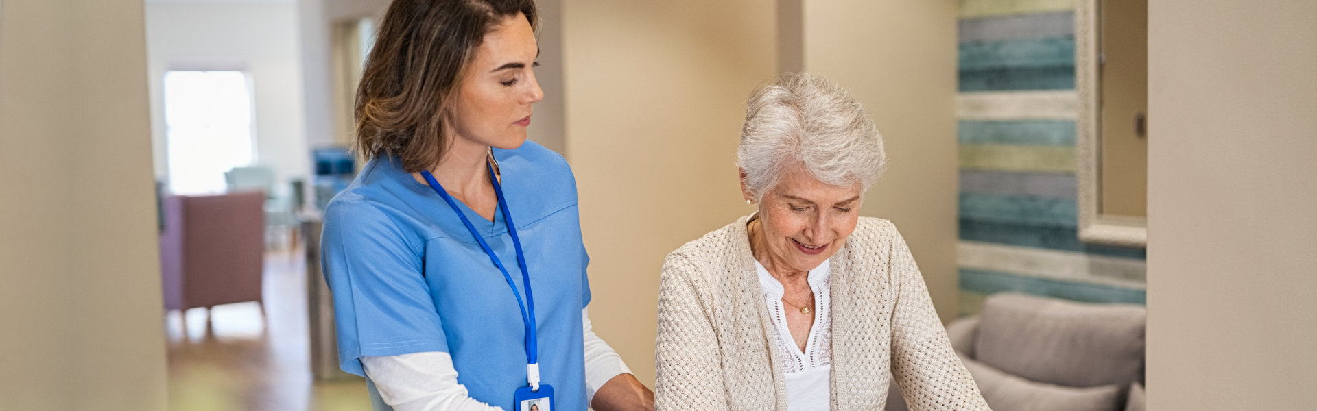 nurse assisting the senior woman while walking