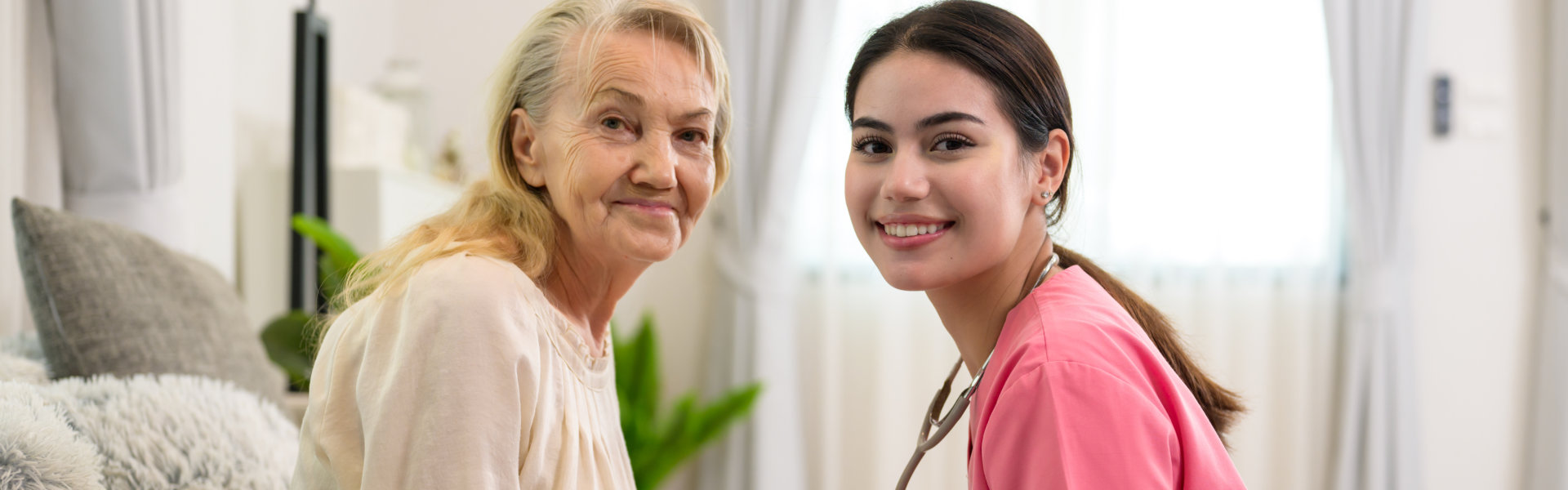 nurse and senior woman in the living room